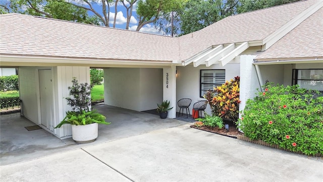 3504 Wedge Way, New Port Richey, FL 34655 - property entrance featuring a shingled roof, driveway, and a carport