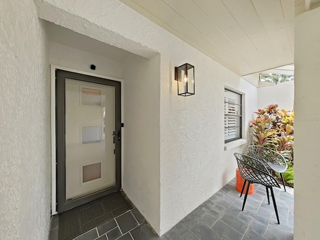 3504 Wedge Way, New Port Richey, FL 34655 - view of exterior entry with stucco siding and a porch