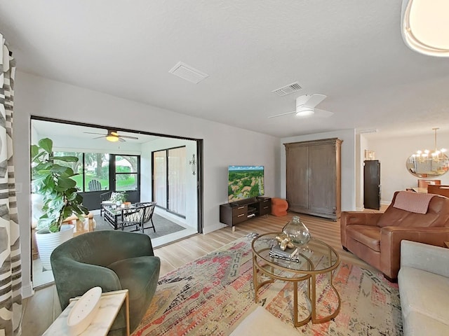 3504 Wedge Way, New Port Richey, FL 34655 - living area featuring ceiling fan, light wood-type flooring, and a chandelier