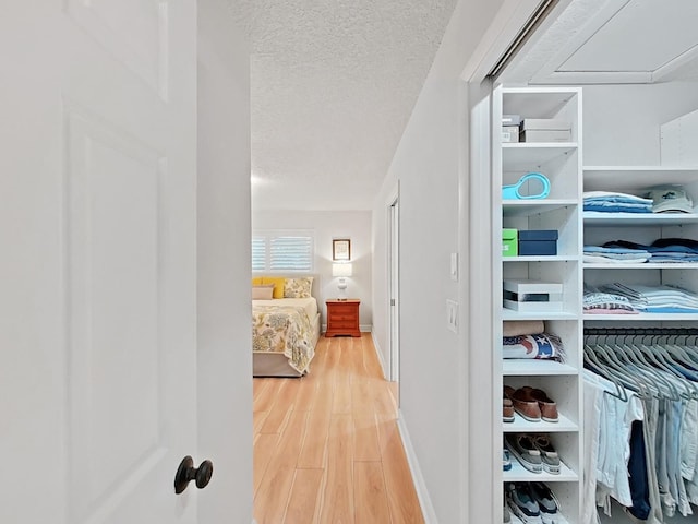 3504 Wedge Way, New Port Richey, FL 34655 - hall with wood finished floors, a textured ceiling, and baseboards