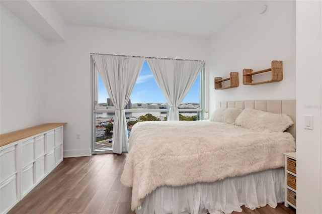 111 N 12th St Unit 1805, Tampa, FL 33602 - bedroom with multiple windows, wood finished floors, and baseboards