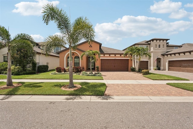 13128 Foxtail Fern Dr, Riverview, FL 33579 - mediterranean / spanish house with decorative driveway, stucco siding, a front yard, and a garage