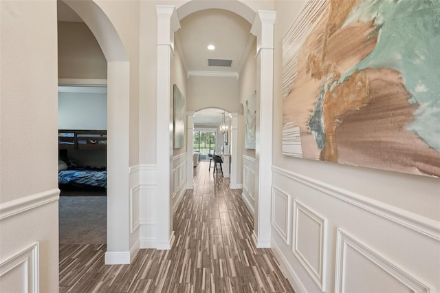 13128 Foxtail Fern Dr, Riverview, FL 33579 - hall with arched walkways, ornamental molding, wood finished floors, ornate columns, and wainscoting