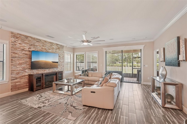 13128 Foxtail Fern Dr, Riverview, FL 33579 - living room with wood finished floors, ceiling fan, crown molding, and a fireplace