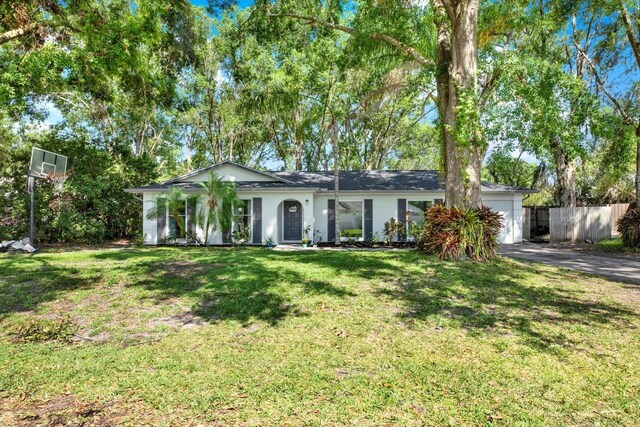 3615 Greatwood Ct, Land O Lakes, FL 34639 - ranch-style home with a garage, asphalt driveway, and stucco siding