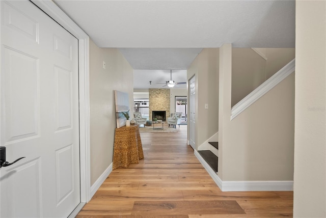 4509 Grainary Ave, Tampa, FL 33624 - hall featuring light wood finished floors, baseboards, and stairway