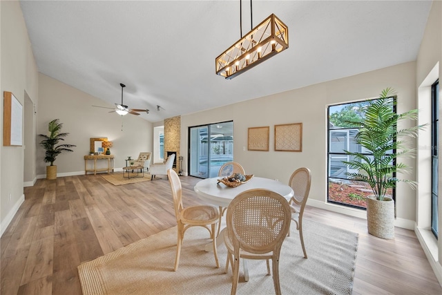 4509 Grainary Ave, Tampa, FL 33624 - dining area featuring vaulted ceiling, light wood-type flooring, ceiling fan, and baseboards