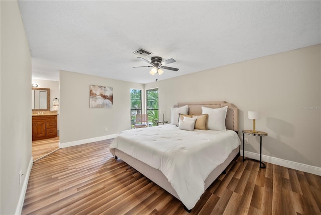 4509 Grainary Ave, Tampa, FL 33624 - bedroom featuring baseboards, wood finished floors, a ceiling fan, and ensuite bath