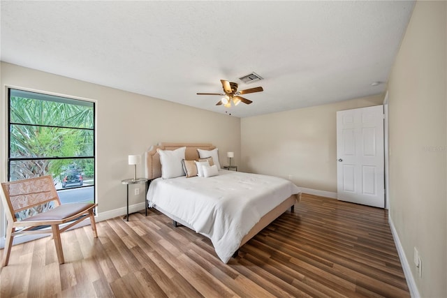 4509 Grainary Ave, Tampa, FL 33624 - bedroom with wood finished floors, baseboards, and ceiling fan
