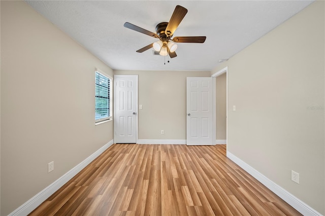 4509 Grainary Ave, Tampa, FL 33624 - empty room featuring baseboards, a ceiling fan, and light wood finished floors
