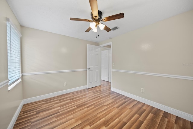 4509 Grainary Ave, Tampa, FL 33624 - unfurnished room featuring baseboards, wood finished floors, ceiling fan, and healthy amount of natural light