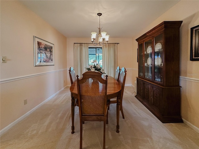5004 Grainary Ave, Tampa, FL 33624 - dining area featuring a chandelier, light carpet, and baseboards