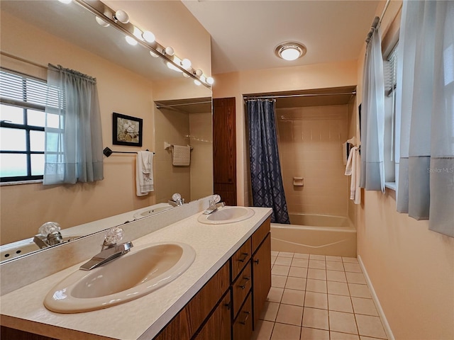 5004 Grainary Ave, Tampa, FL 33624 - full bathroom featuring tile patterned floors, double vanity, shower / bath combo with shower curtain, and baseboards