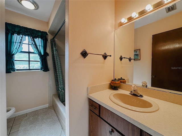 5004 Grainary Ave, Tampa, FL 33624 - bathroom with toilet, vanity, tile patterned flooring, and shower / bath combo
