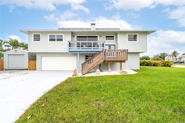 4916 Palmetto Point Dr, Palmetto, FL 34221 - rear view of house featuring an attached garage, a yard, stairway, a chimney, and driveway