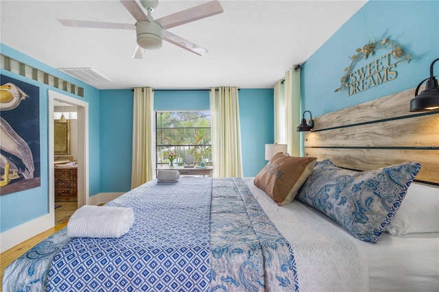 4916 Palmetto Point Dr, Palmetto, FL 34221 - bedroom with wood finished floors, ensuite bathroom, ceiling fan, and baseboards