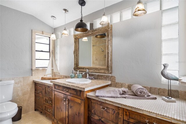 4916 Palmetto Point Dr, Palmetto, FL 34221 - bathroom featuring toilet, vanity, a textured wall, tile walls, and tile patterned floors