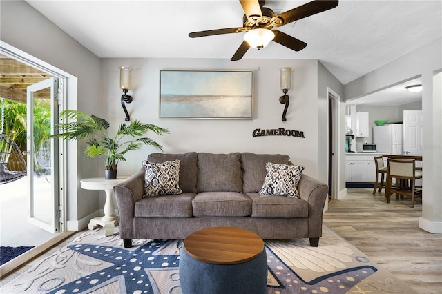 4916 Palmetto Point Dr, Palmetto, FL 34221 - living area with light wood finished floors, a ceiling fan, and baseboards