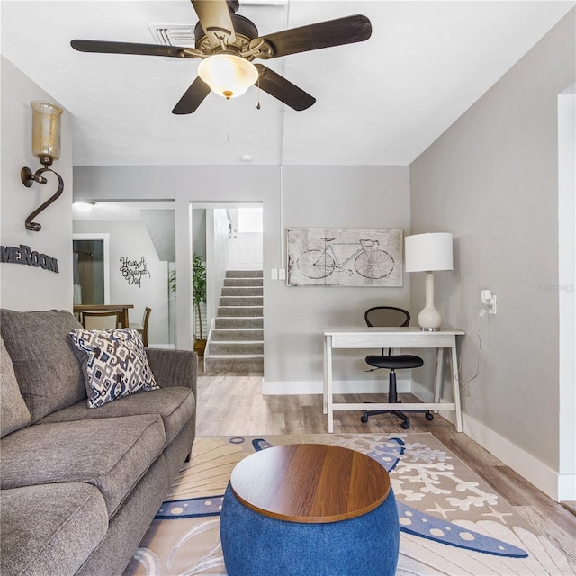 4916 Palmetto Point Dr, Palmetto, FL 34221 - living area featuring wood finished floors, a ceiling fan, baseboards, and stairway