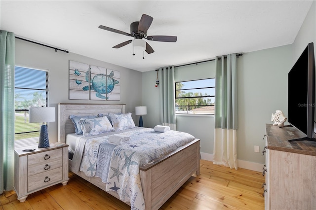 4916 Palmetto Point Dr, Palmetto, FL 34221 - bedroom with light wood-style flooring, baseboards, and a ceiling fan