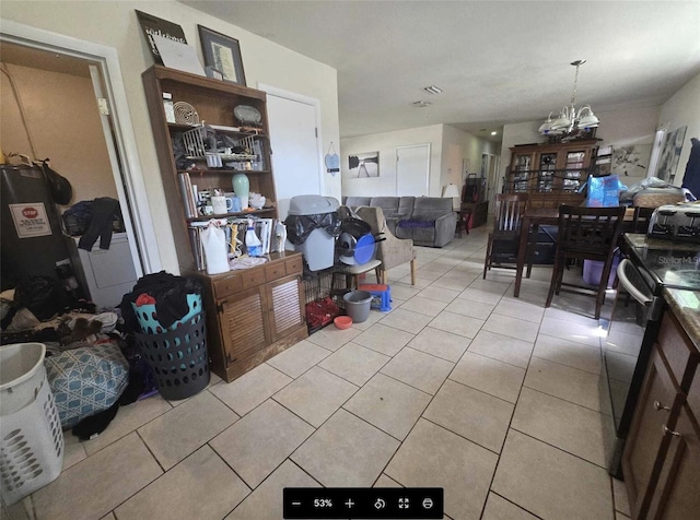 3074 NE Garden Ter, Palm Bay, FL 32905 - kitchen featuring stove, light tile patterned flooring, open floor plan, and a chandelier
