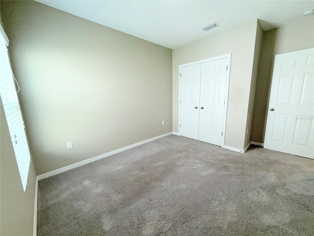 13118 Zolo Springs Cir, Riverview, FL 33579 - unfurnished bedroom with carpet floors, baseboards, and a closet