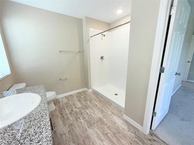 13118 Zolo Springs Cir, Riverview, FL 33579 - bathroom with toilet, tiled shower, wood finished floors, baseboards, and vanity