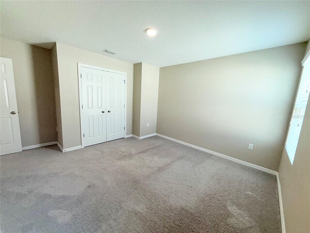 13118 Zolo Springs Cir, Riverview, FL 33579 - unfurnished bedroom with carpet flooring, baseboards, and a closet