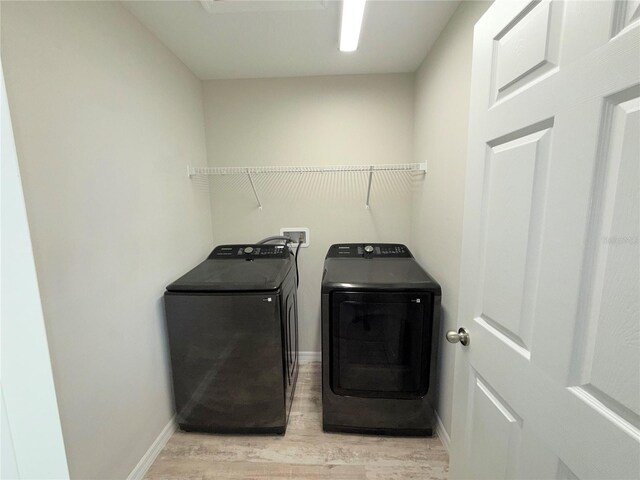 13118 Zolo Springs Cir, Riverview, FL 33579 - washroom featuring separate washer and dryer, light wood finished floors, and baseboards