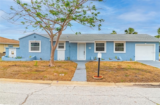 410 Virginia Ave, Madeira Beach, FL 33708 - view of front of property featuring stucco siding, an attached garage, concrete driveway, and a shingled roof