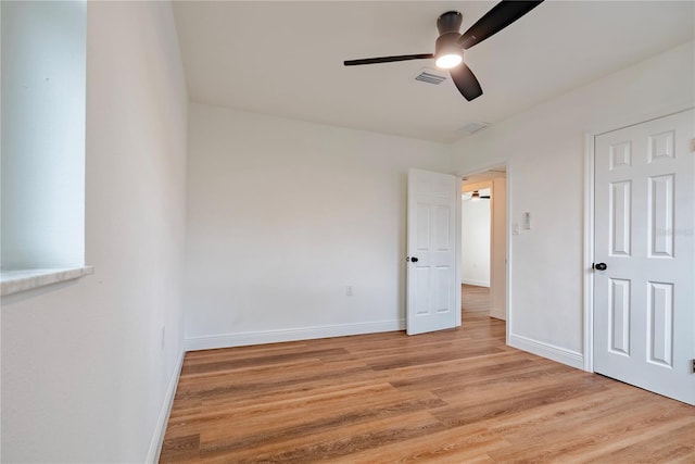 410 Virginia Ave, Madeira Beach, FL 33708 - unfurnished bedroom featuring light wood finished floors, baseboards, and ceiling fan