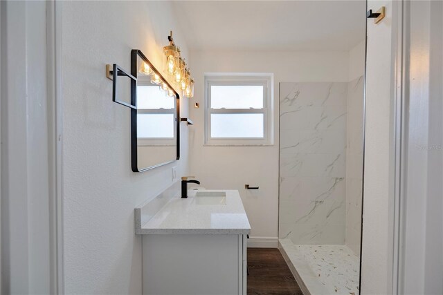 410 Virginia Ave, Madeira Beach, FL 33708 - bathroom featuring vanity, a marble finish shower, and wood finished floors