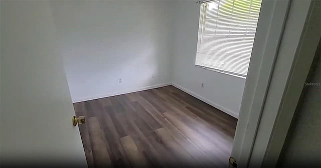 3513 Danny Bryan Blvd, Tampa, FL 33619 - spare room featuring dark wood-style floors and baseboards