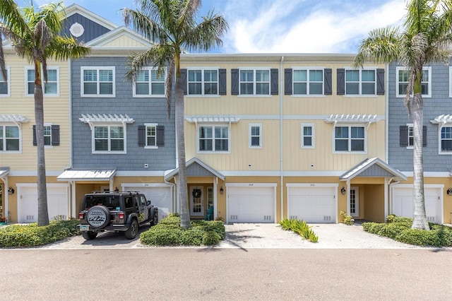 204 Haven Beach Ct, Indian Rocks Beach, FL 33785 - townhome / multi-family property with an attached garage and driveway