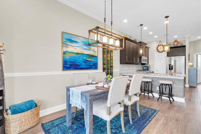 204 Haven Beach Ct, Indian Rocks Beach, FL 33785 - dining space featuring light wood finished floors and recessed lighting