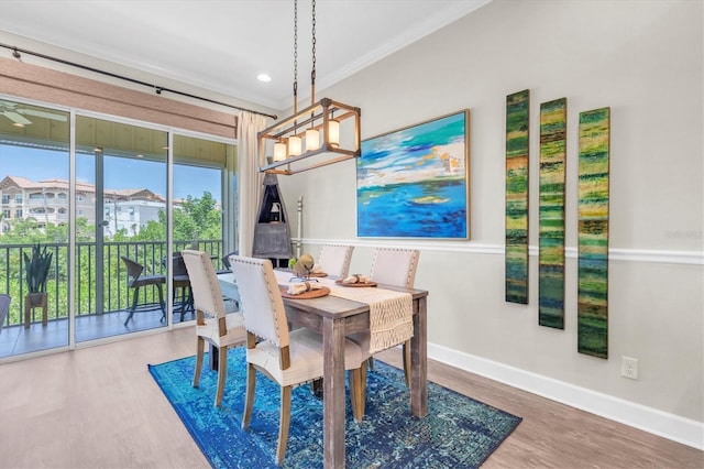 204 Haven Beach Ct, Indian Rocks Beach, FL 33785 - dining room with crown molding, wood finished floors, a chandelier, and recessed lighting