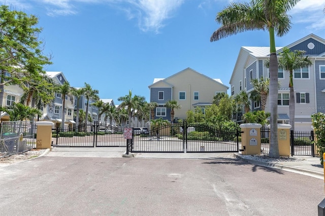 204 Haven Beach Ct, Indian Rocks Beach, FL 33785 - view of asphalt street with a gate, a residential view, and a gated entry