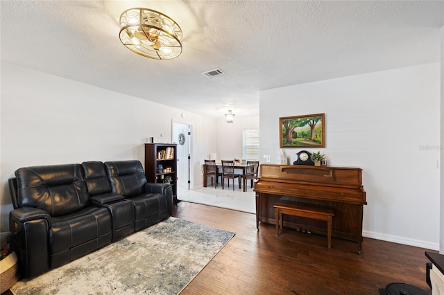 3983 Shay Dr, Bartow, FL 33830 - living room featuring wood finished floors, a textured ceiling, and a chandelier