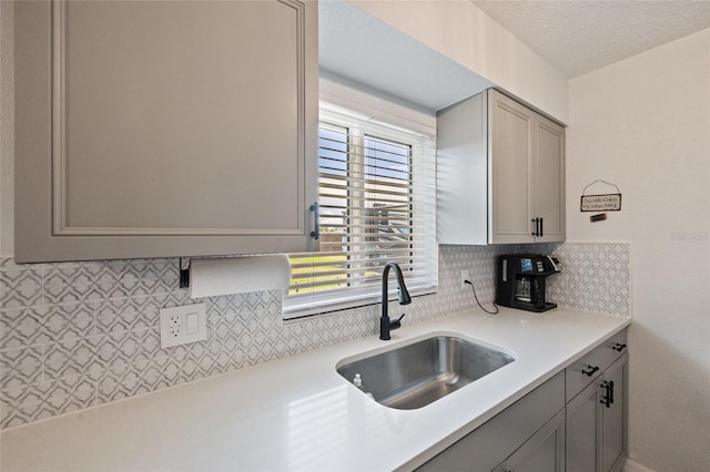 3983 Shay Dr, Bartow, FL 33830 - kitchen with gray cabinetry, tasteful backsplash, light countertops, and a textured ceiling