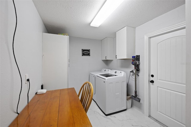 3983 Shay Dr, Bartow, FL 33830 - laundry area with cabinet space, light marble finish flooring, a textured ceiling, and washer and clothes dryer