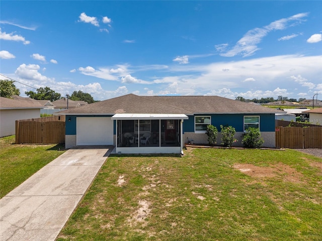 3983 Shay Dr, Bartow, FL 33830 - back of house with a sunroom, an attached garage, concrete driveway, a shingled roof, and stucco siding