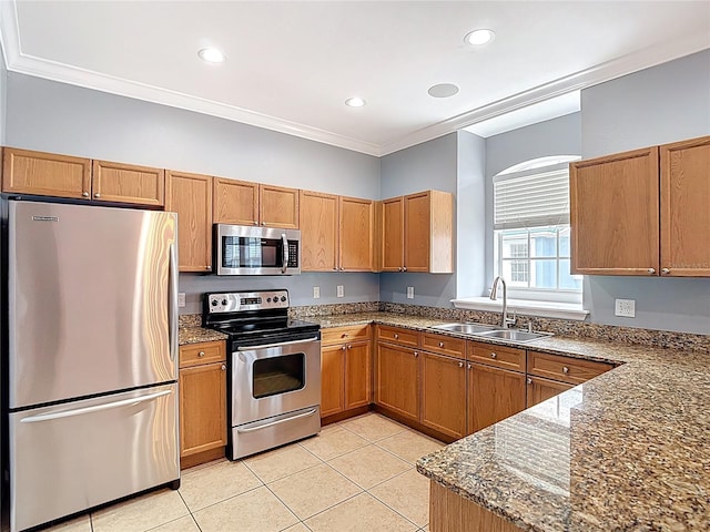 3111 W De Leon St Unit 2, Tampa, FL 33609 - kitchen with appliances with stainless steel finishes, a sink, ornamental molding, light tile patterned flooring, and brown cabinets