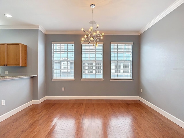 3111 W De Leon St Unit 2, Tampa, FL 33609 - unfurnished dining area featuring plenty of natural light, a chandelier, hardwood / wood-style floors, baseboards, and ornamental molding