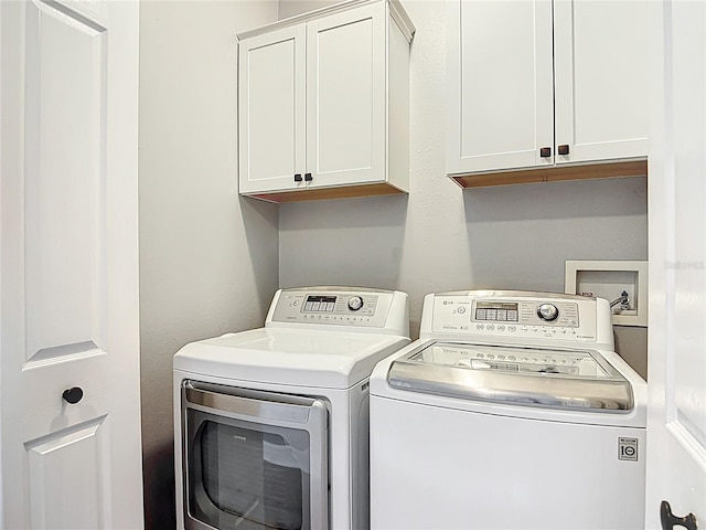 3111 W De Leon St Unit 2, Tampa, FL 33609 - laundry area featuring cabinet space and washer and dryer