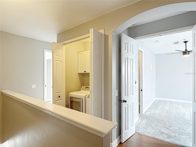 3111 W De Leon St Unit 2, Tampa, FL 33609 - corridor featuring wood finished floors, washing machine and clothes dryer, arched walkways, and baseboards