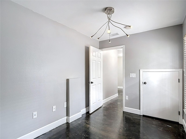 3111 W De Leon St Unit 2, Tampa, FL 33609 - spare room with baseboards, a chandelier, and concrete floors