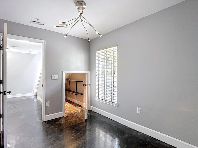 3111 W De Leon St Unit 2, Tampa, FL 33609 - unfurnished room featuring concrete floors, baseboards, and a chandelier