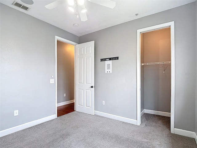 3111 W De Leon St Unit 2, Tampa, FL 33609 - unfurnished bedroom featuring carpet flooring, baseboards, a closet, ceiling fan, and a walk in closet