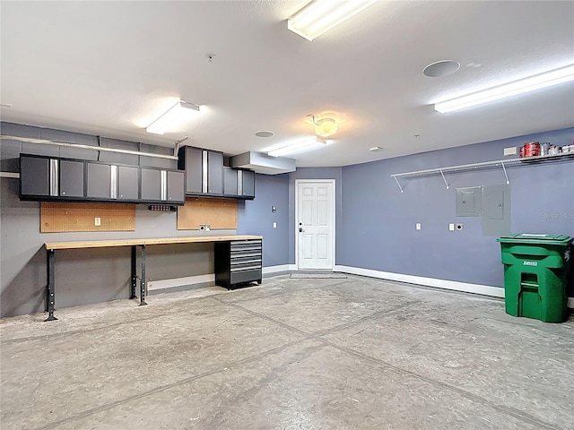 3111 W De Leon St Unit 2, Tampa, FL 33609 - garage featuring baseboards and electric panel