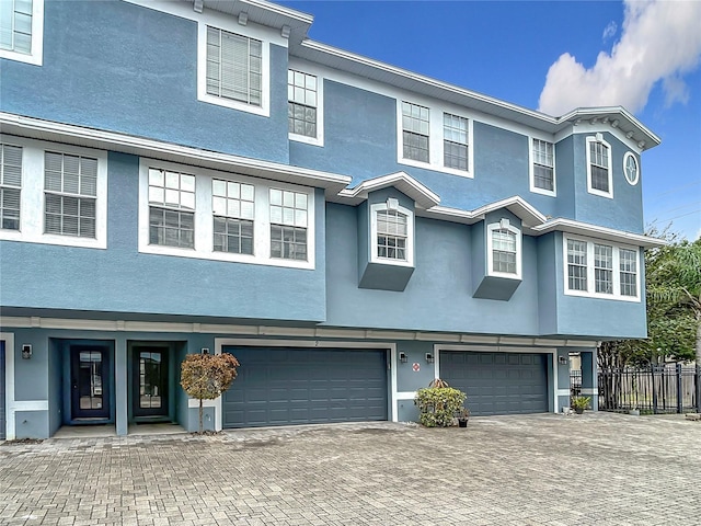3111 W De Leon St Unit 2, Tampa, FL 33609 - townhome / multi-family property with an attached garage, stucco siding, and driveway